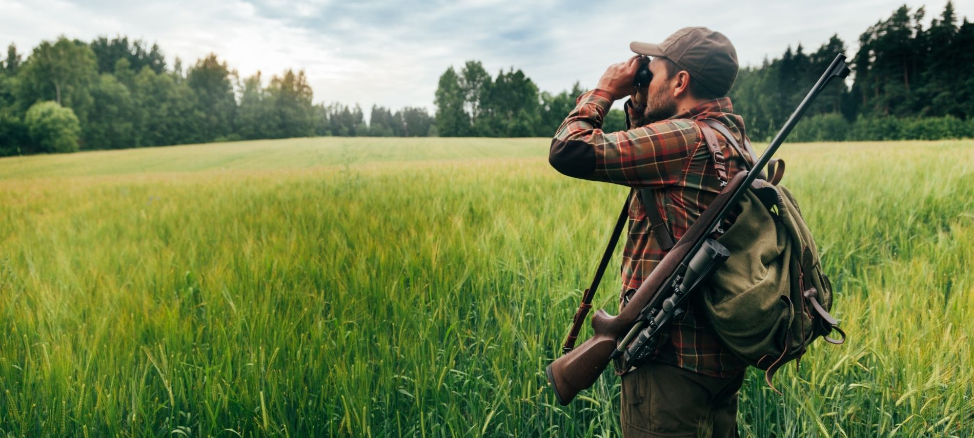 a hunter is looking through binoculars