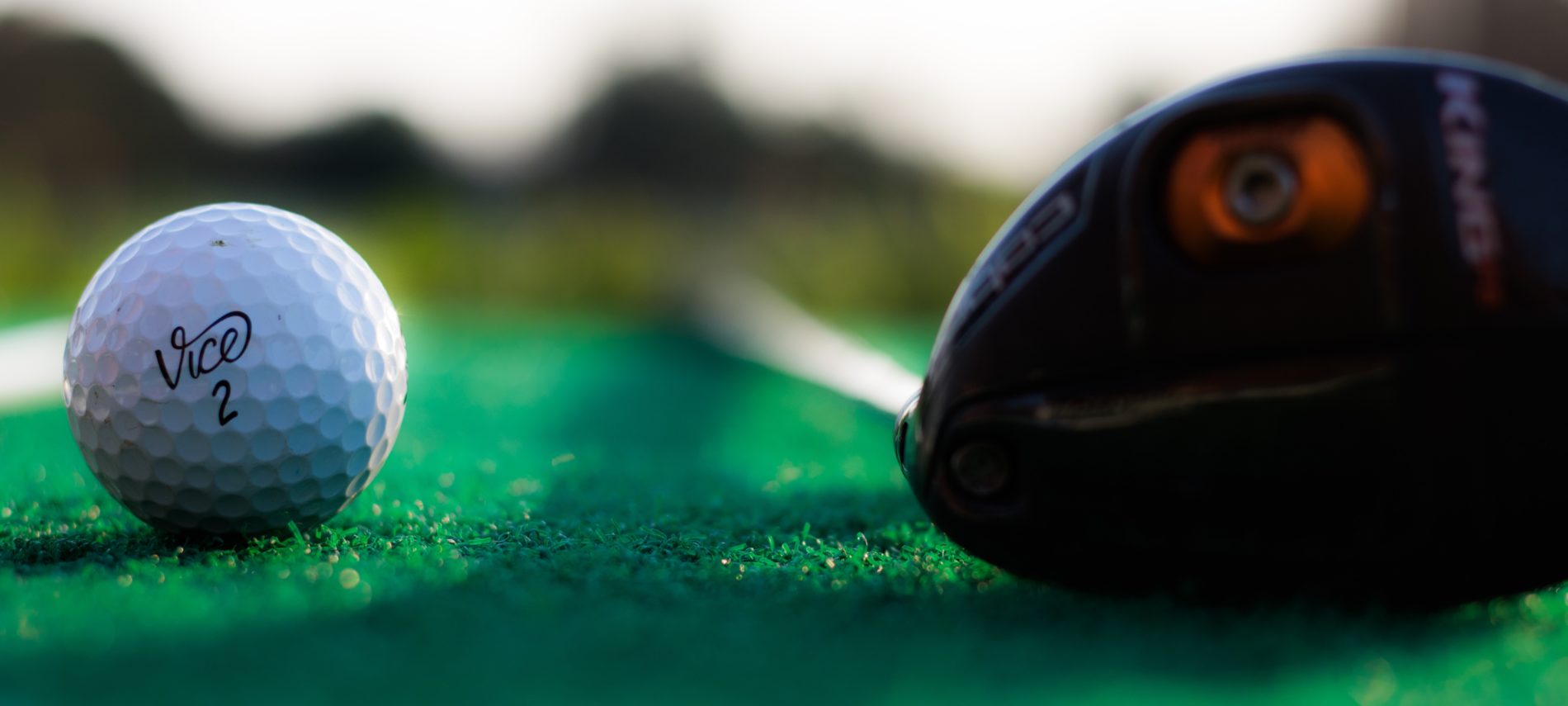 Close up view of a ball and driver.